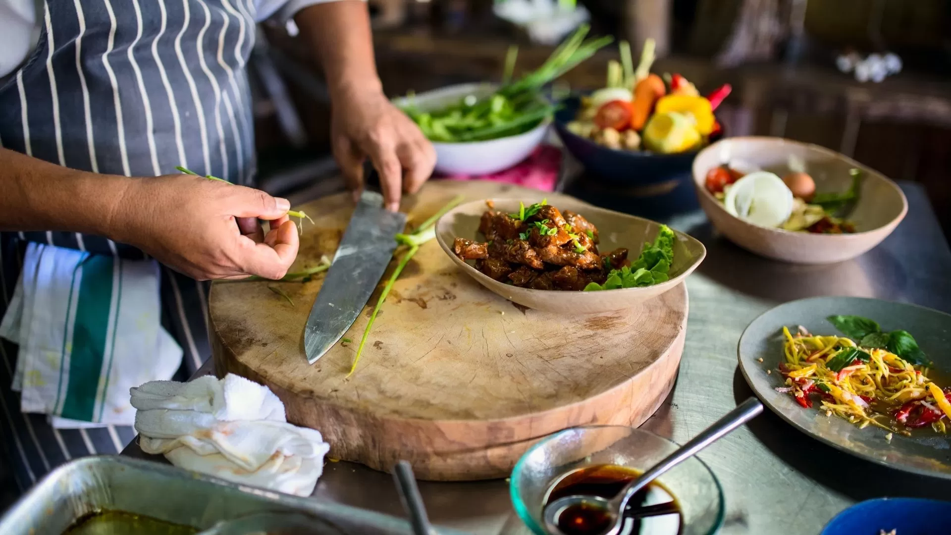 Joining a traditional Cambodian cooking class and learning local recipes.