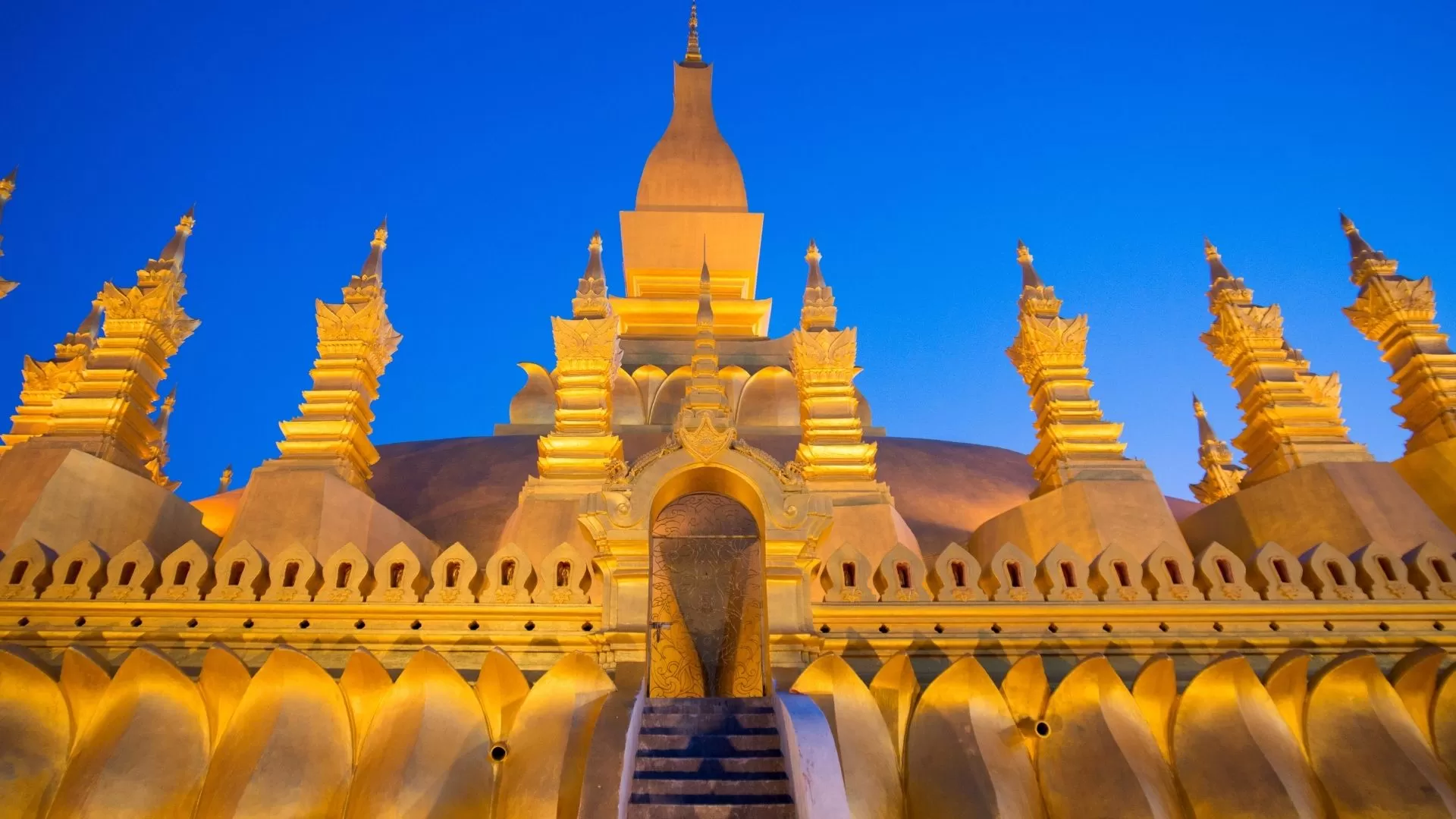 Golden Stupa with layered tiers and gold-covered spire, showcasing Lao Buddhist architecture.