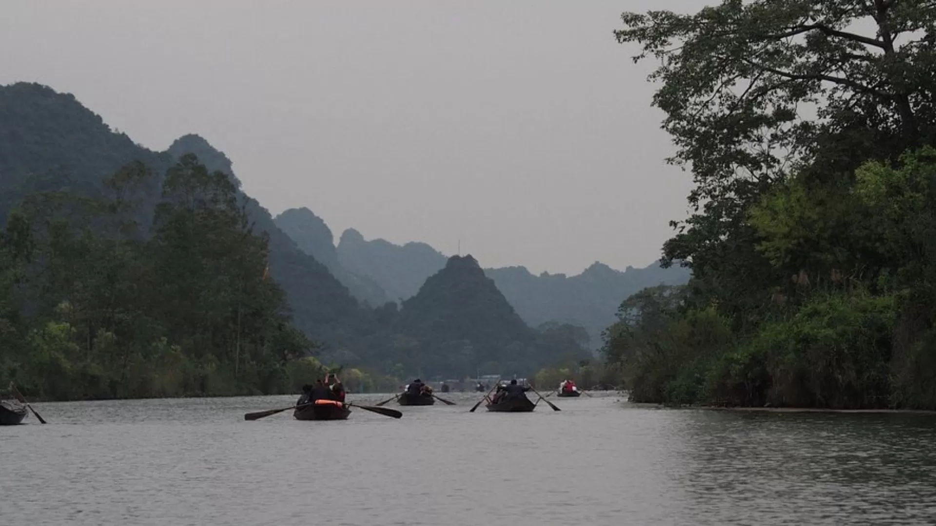 Boat ride to the Perfume Pagoda through scenic waterways.